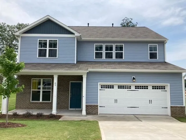 a view of a house with a yard and sitting area