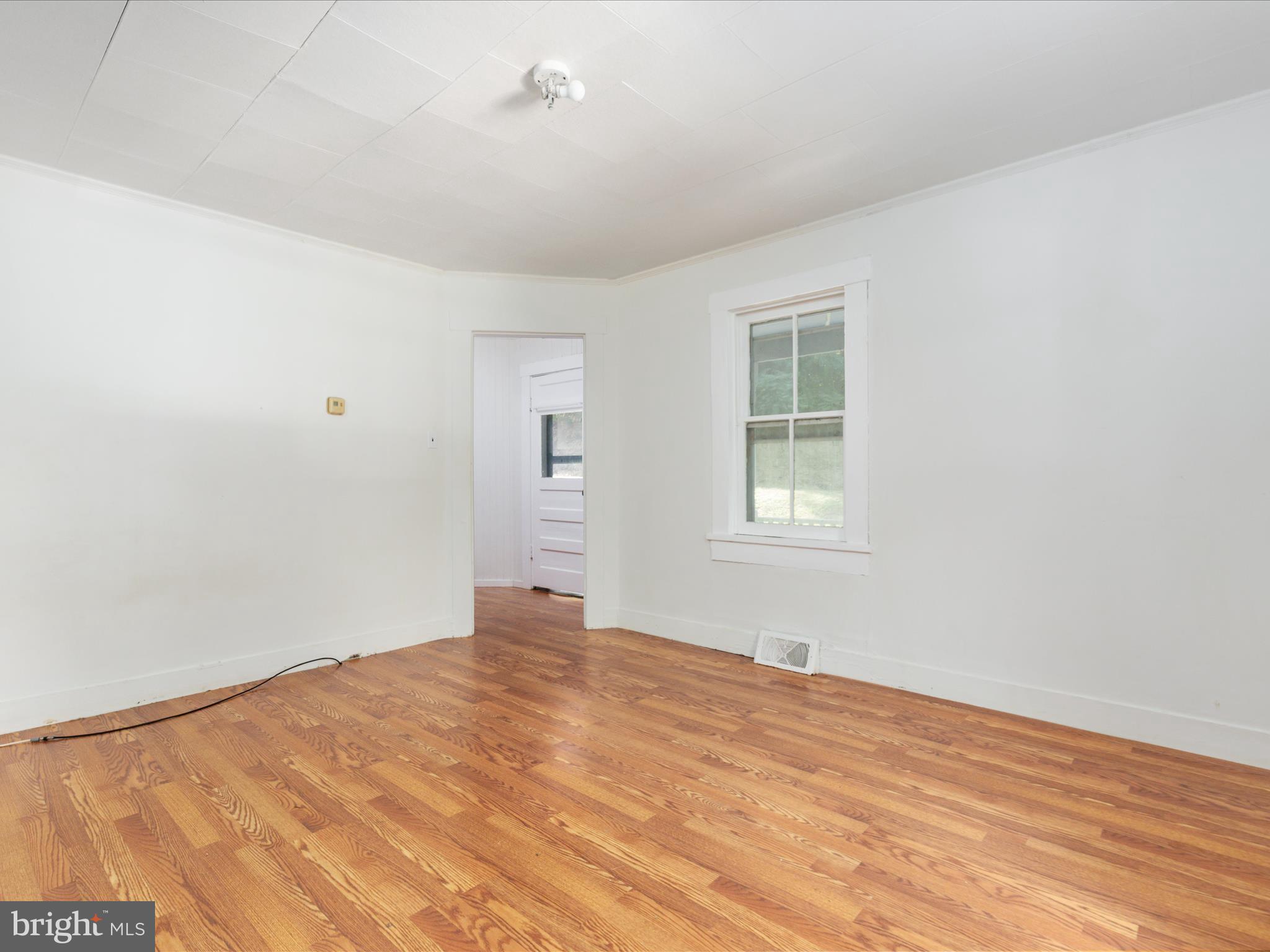 141 Back Creek Road Gore, VA 22637 - Photo 12 of 53 a view of empty room with wooden floor and fan