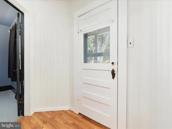 a view of bedroom with a bed and wooden floor