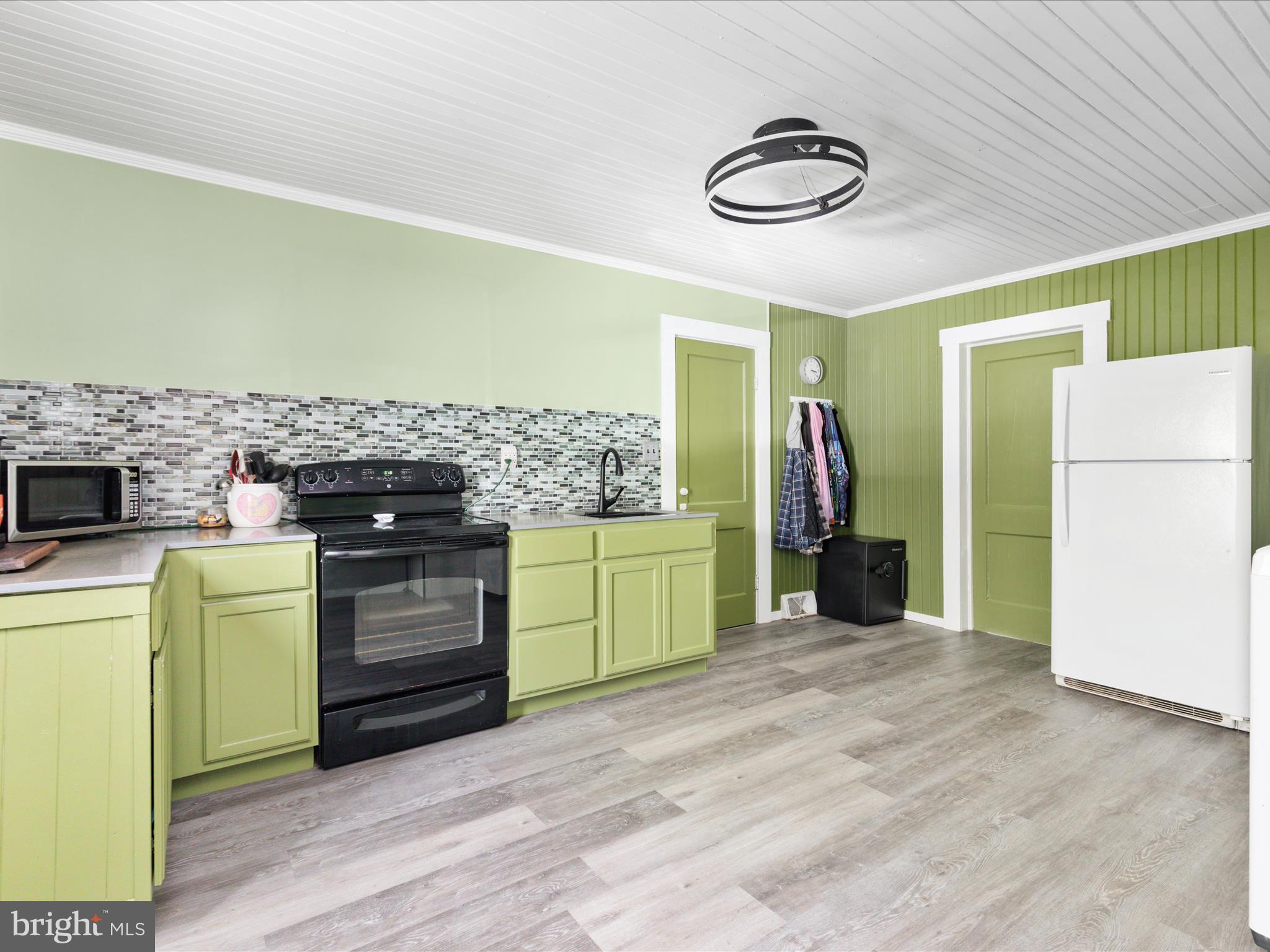 141 Back Creek Road Gore, VA 22637 - Photo 7 of 53 a kitchen with a refrigerator and a stove top oven