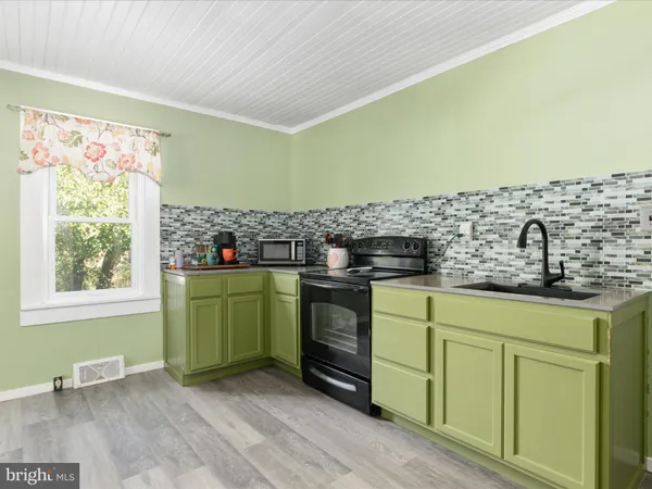 a kitchen with a sink and a stove top oven