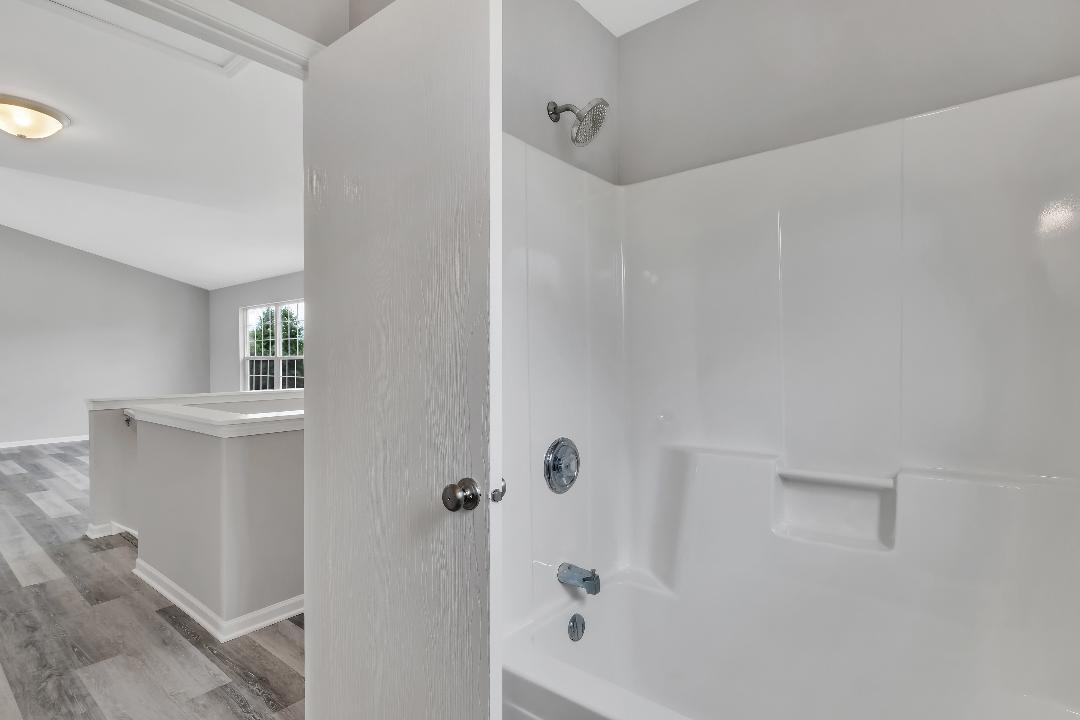 303 Joshua Tree Harvard, IL 60033 - Photo 7 of 14 a bathroom with a bathtub and shower