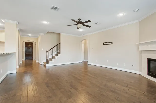 a view of a kitchen with a sink and wooden floor