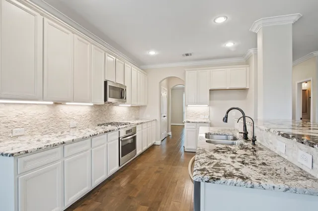 a kitchen with a stove and a white cabinets
