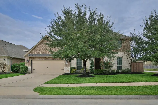a spacious bedroom with a bed painting and a large window