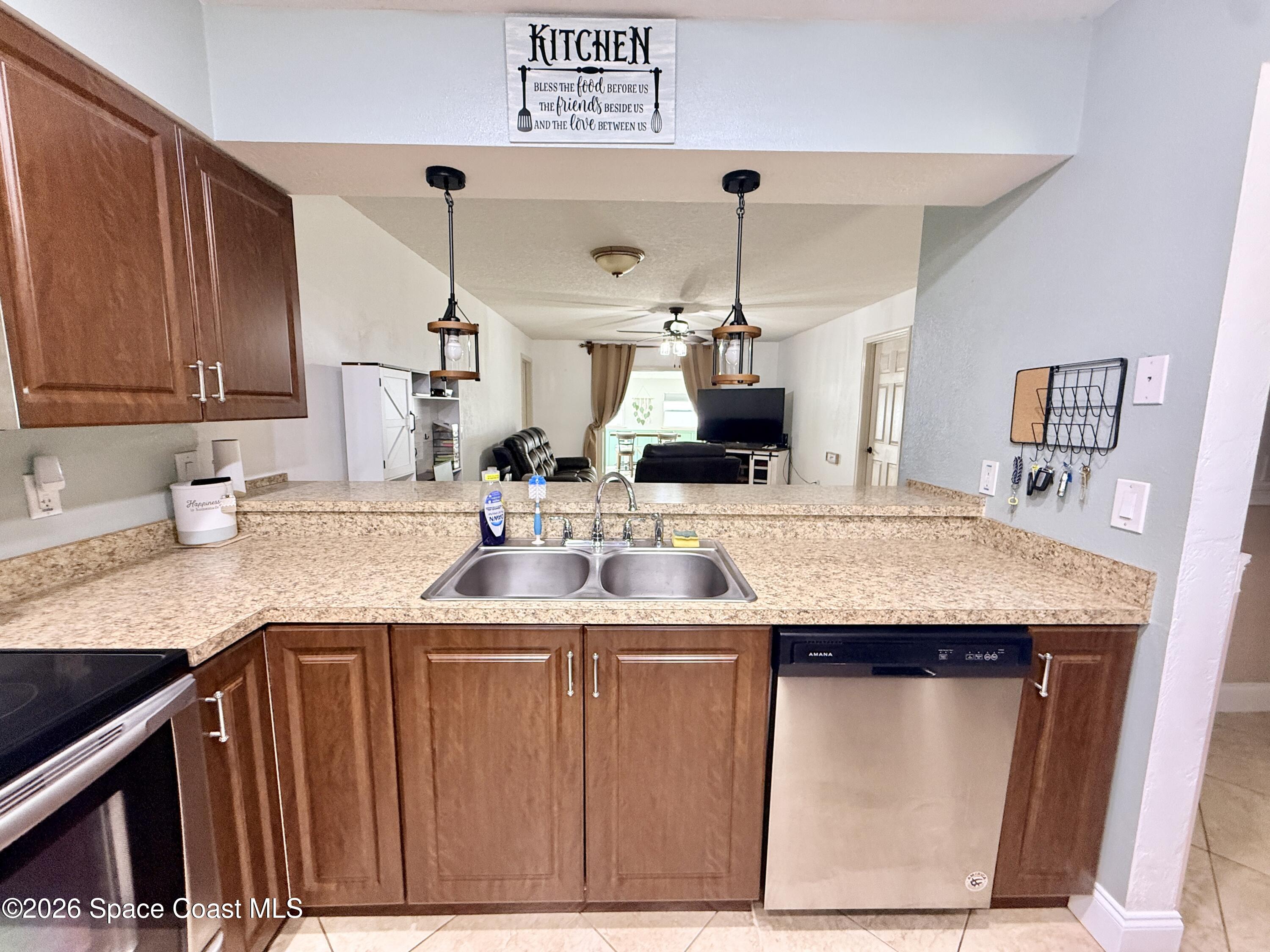 1046 West Samms Avenue Port Orange, FL 32129 - Photo 11 of 53 a kitchen with stainless steel appliances kitchen island a sink and cabinets