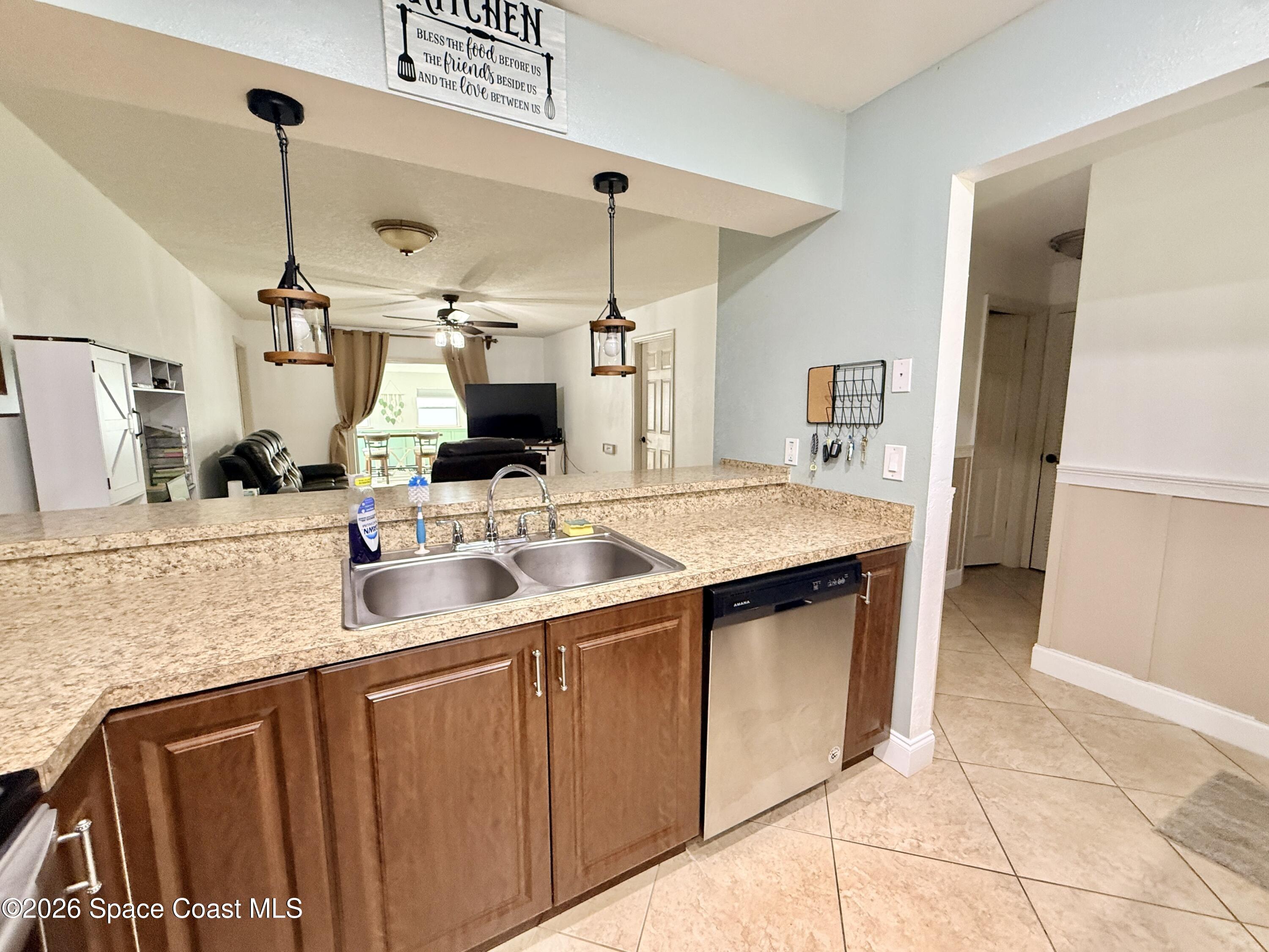 1046 West Samms Avenue Port Orange, FL 32129 - Photo 12 of 53 a kitchen with a sink a counter top space and cabinets