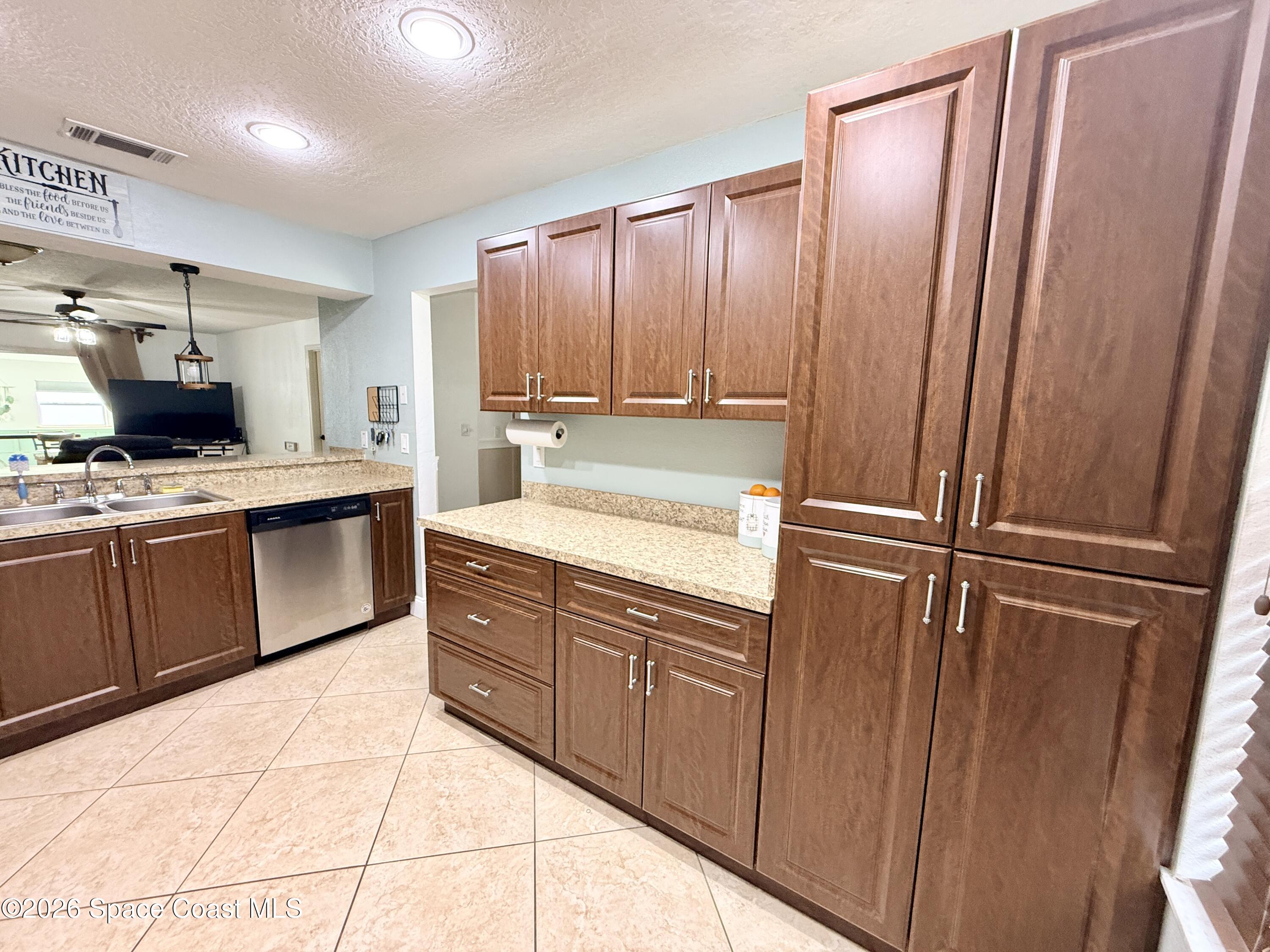 1046 West Samms Avenue Port Orange, FL 32129 - Photo 13 of 53 a kitchen with stainless steel appliances a refrigerator sink and cabinets