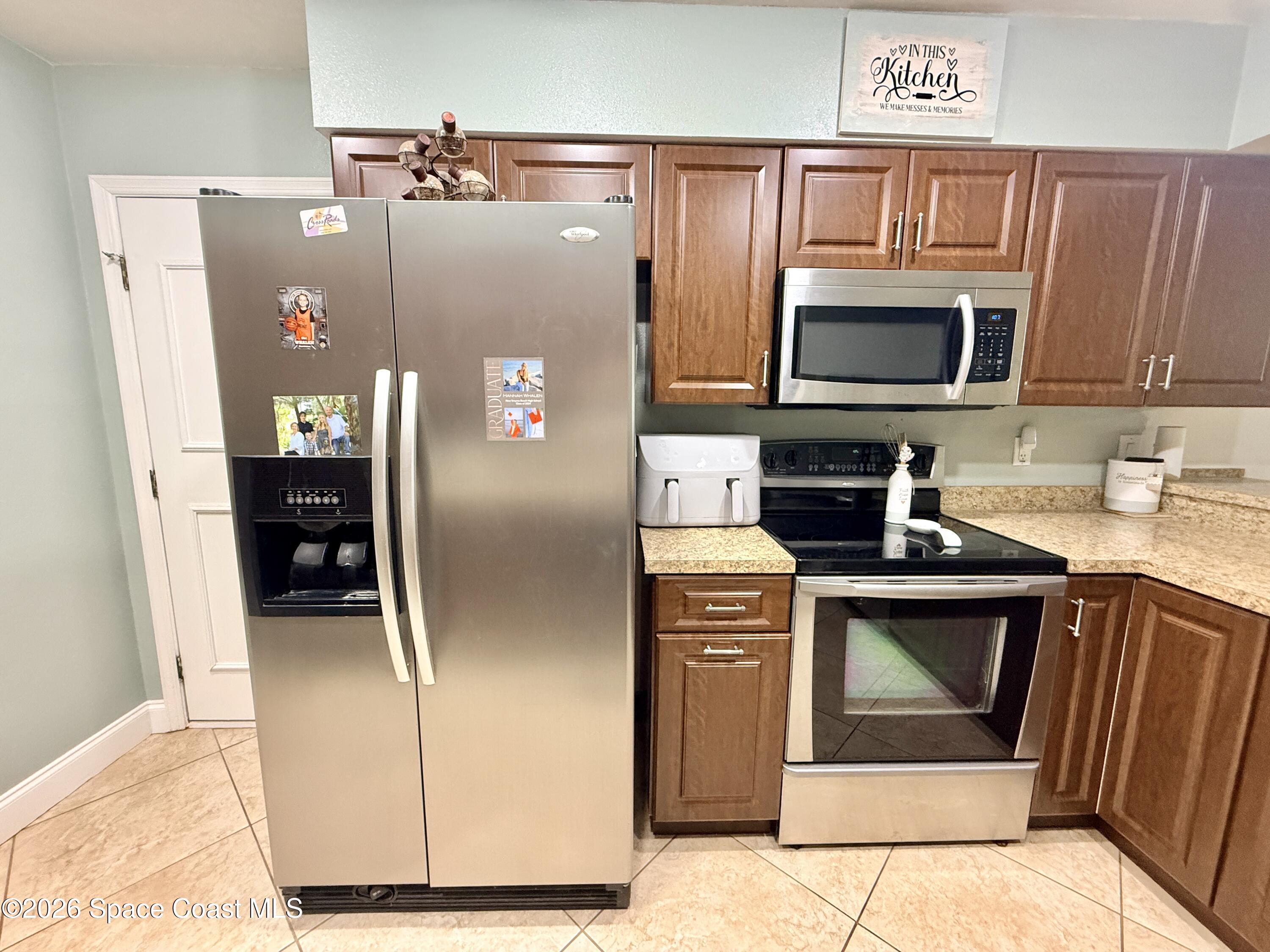 1046 West Samms Avenue Port Orange, FL 32129 - Photo 16 of 53 a kitchen with stainless steel appliances granite countertop a refrigerator stove and microwave