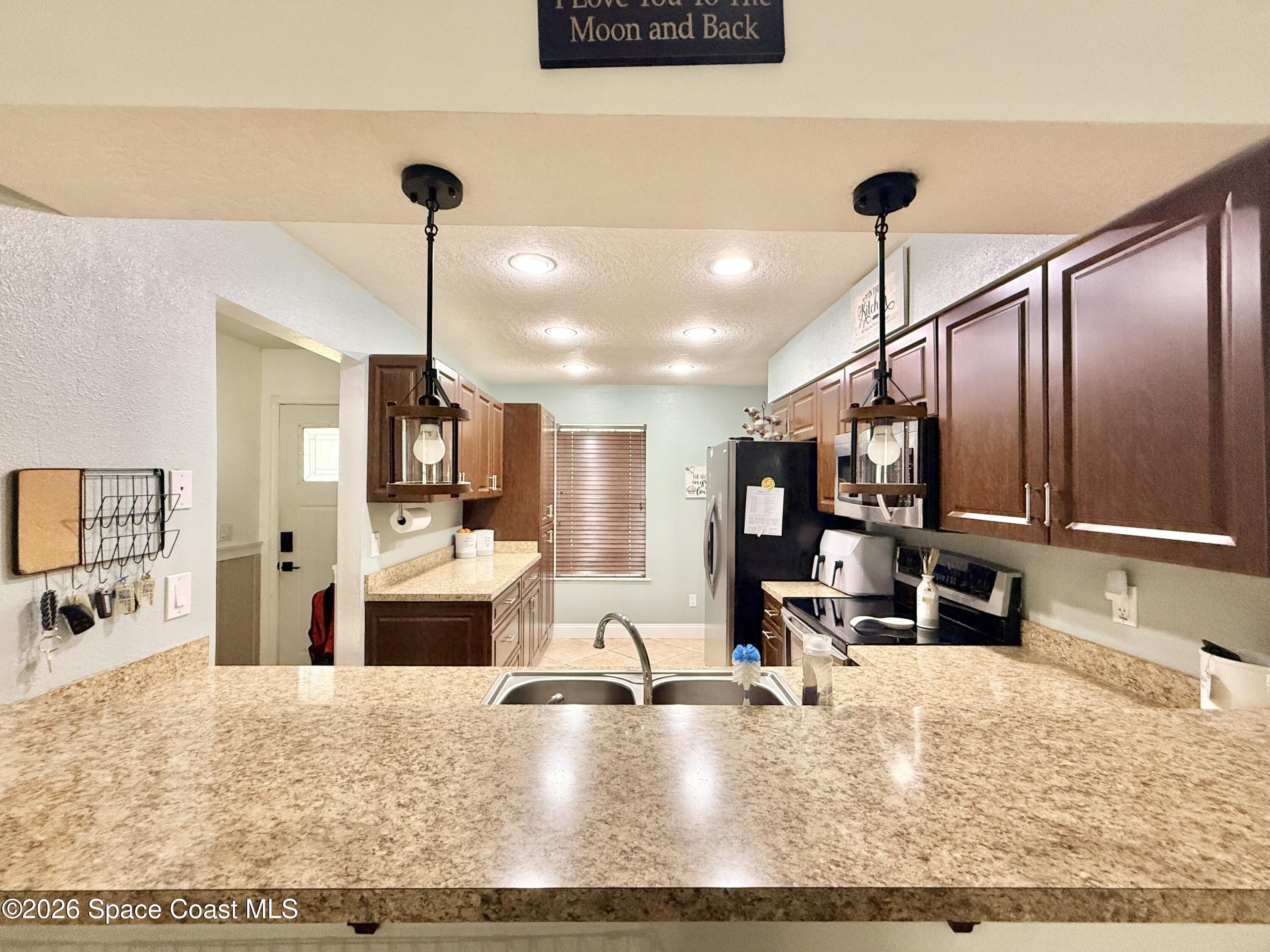 1046 West Samms Avenue Port Orange, FL 32129 - Photo 18 of 53 a kitchen with kitchen island a counter top space a sink and appliances