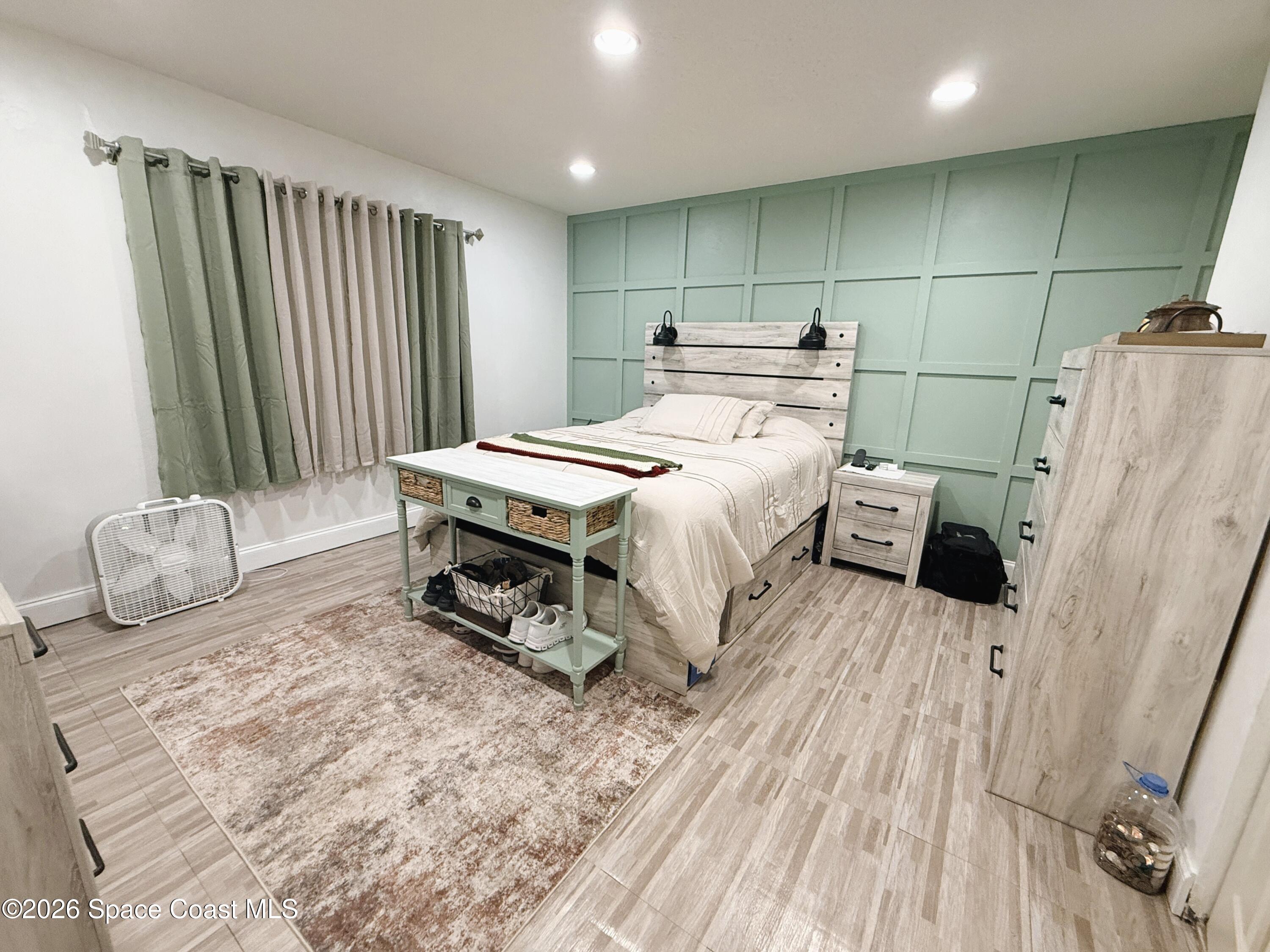 1046 West Samms Avenue Port Orange, FL 32129 - Photo 20 of 53 a bedroom with a bed and a mirror