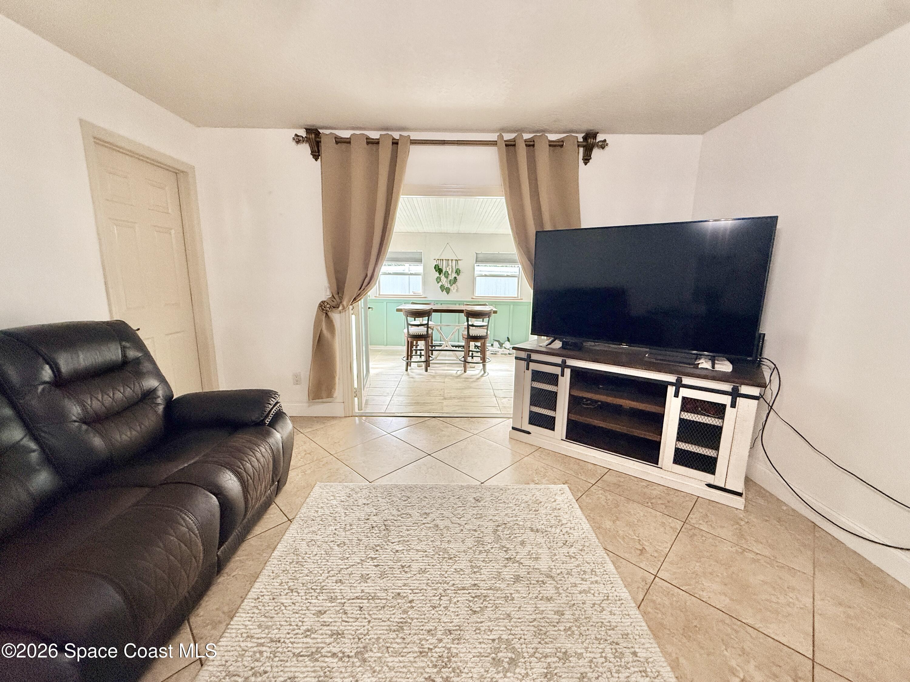 1046 West Samms Avenue Port Orange, FL 32129 - Photo 2 of 53 a living room with furniture a flat screen tv and a fireplace