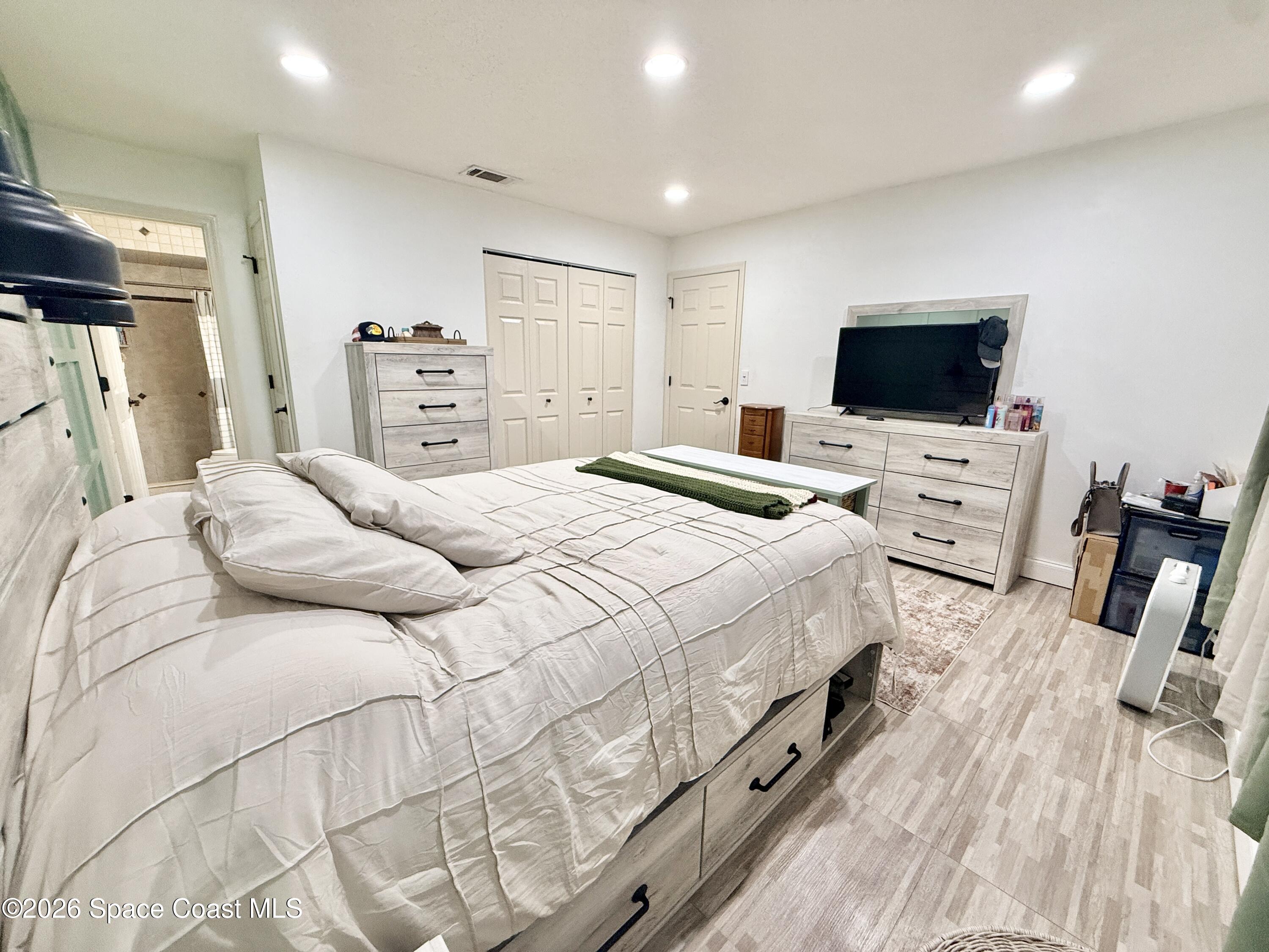 1046 West Samms Avenue Port Orange, FL 32129 - Photo 22 of 53 a bedroom with a bed and a flat screen tv