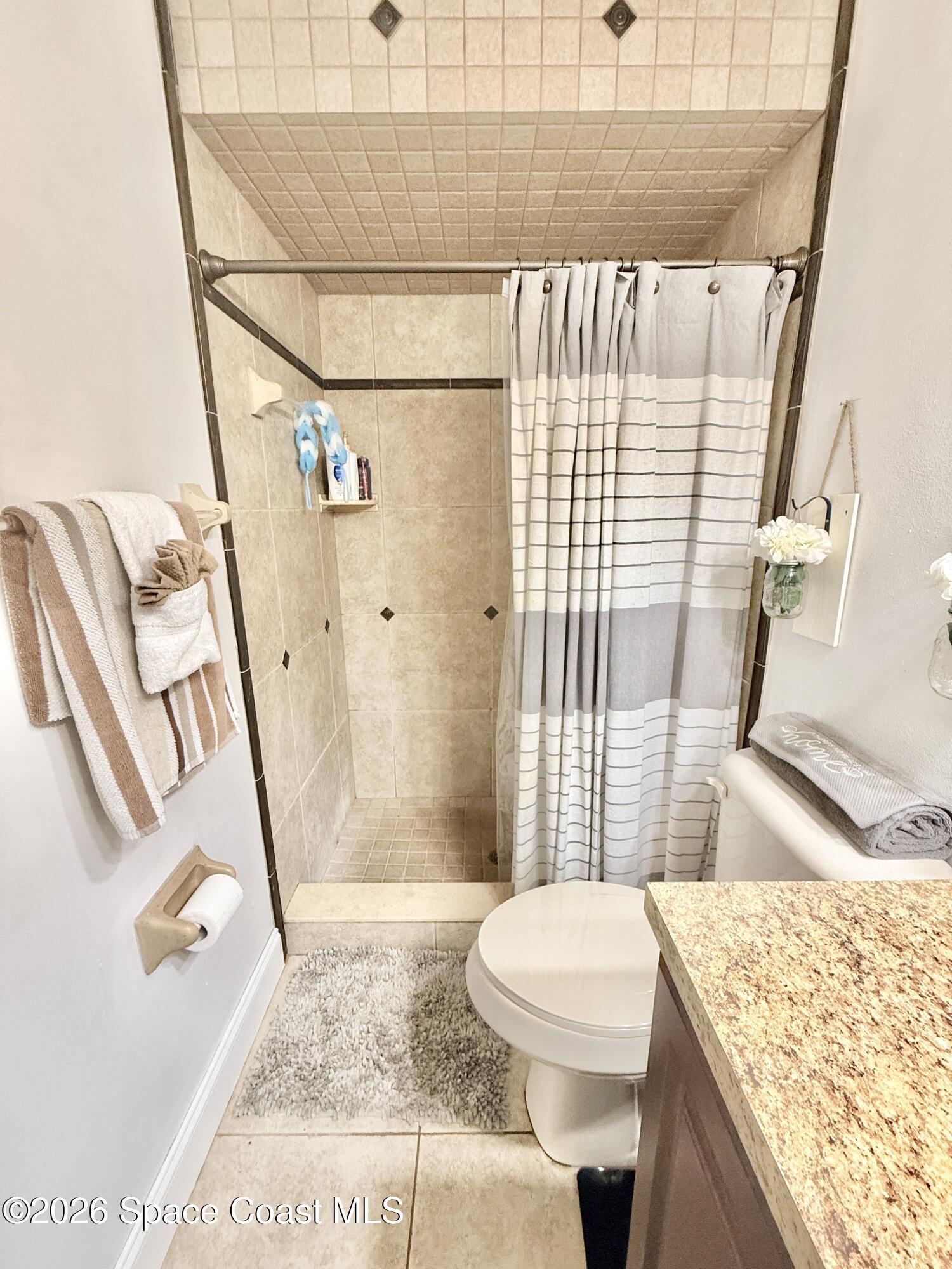 1046 West Samms Avenue Port Orange, FL 32129 - Photo 23 of 53 a bathroom with a granite countertop sink toilet and shower