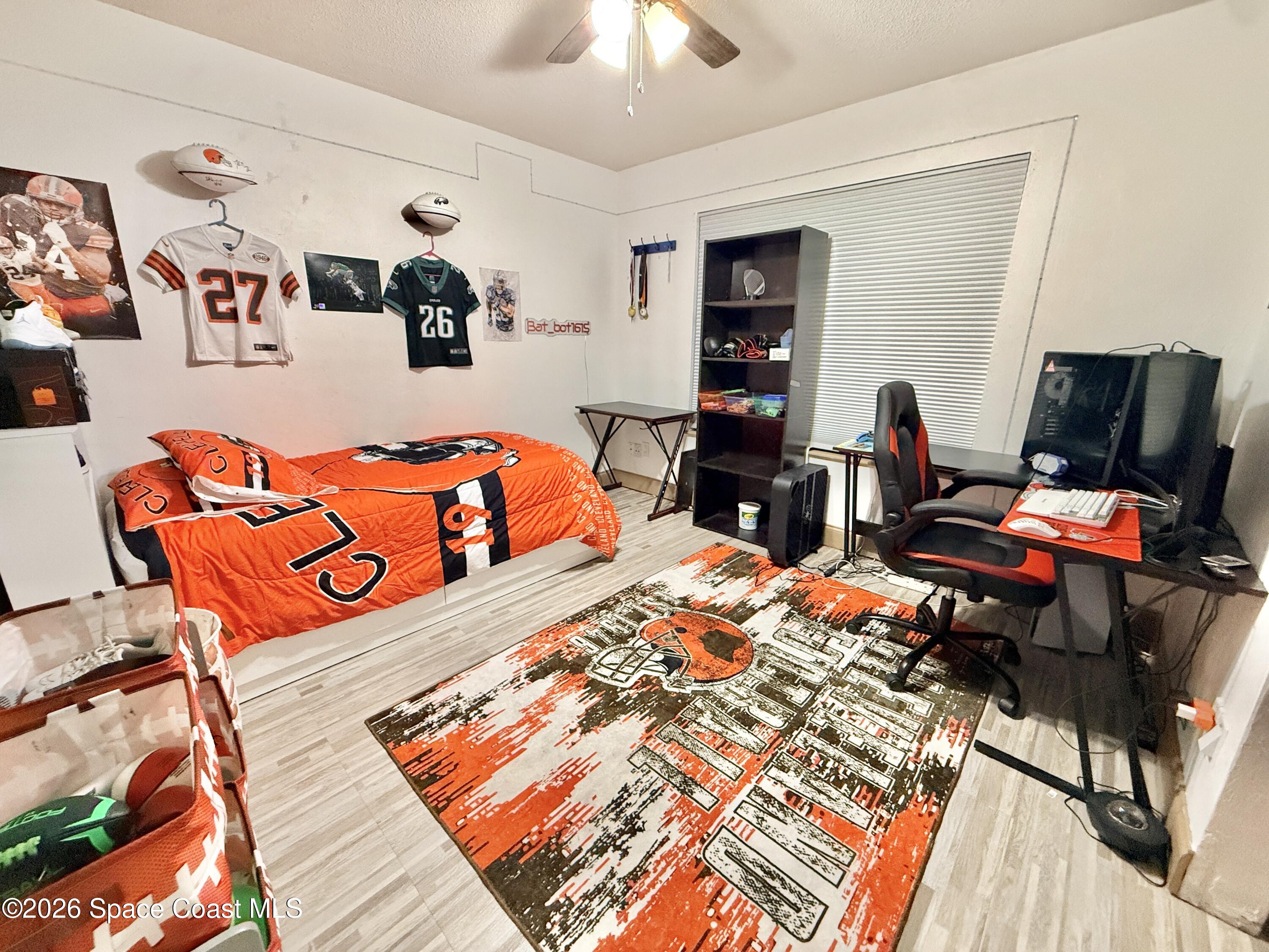 1046 West Samms Avenue Port Orange, FL 32129 - Photo 27 of 53 a bedroom with furniture and flat screen tv