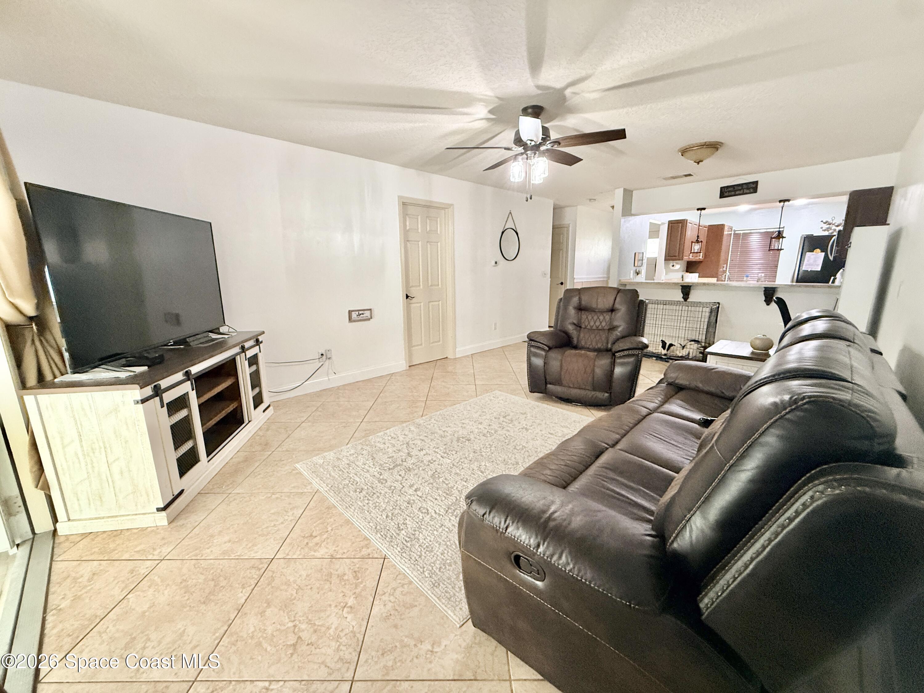 1046 West Samms Avenue Port Orange, FL 32129 - Photo 35 of 53 a living room with furniture and a flat screen tv
