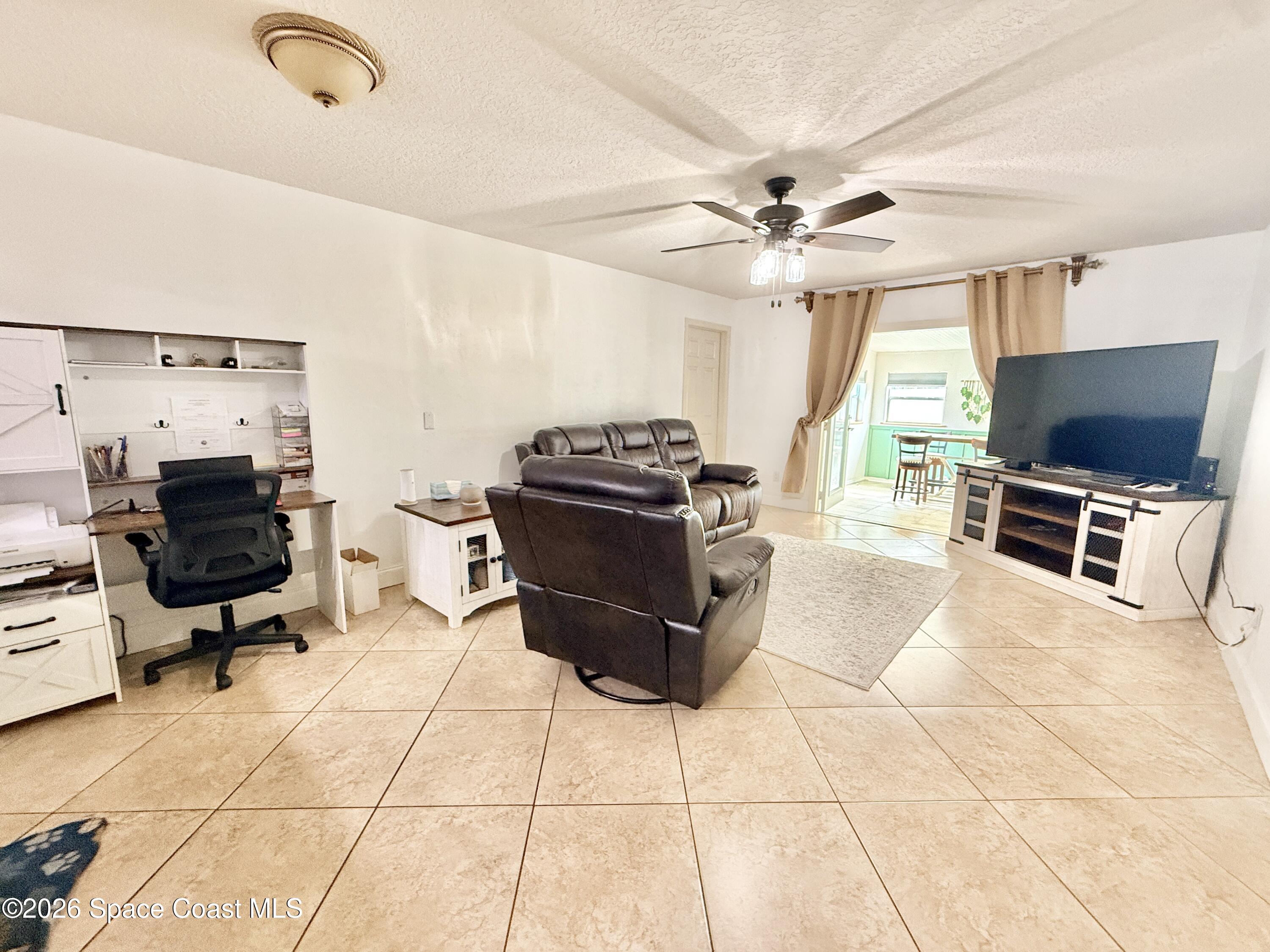 1046 West Samms Avenue Port Orange, FL 32129 - Photo 36 of 53 a living room with furniture and a flat screen tv