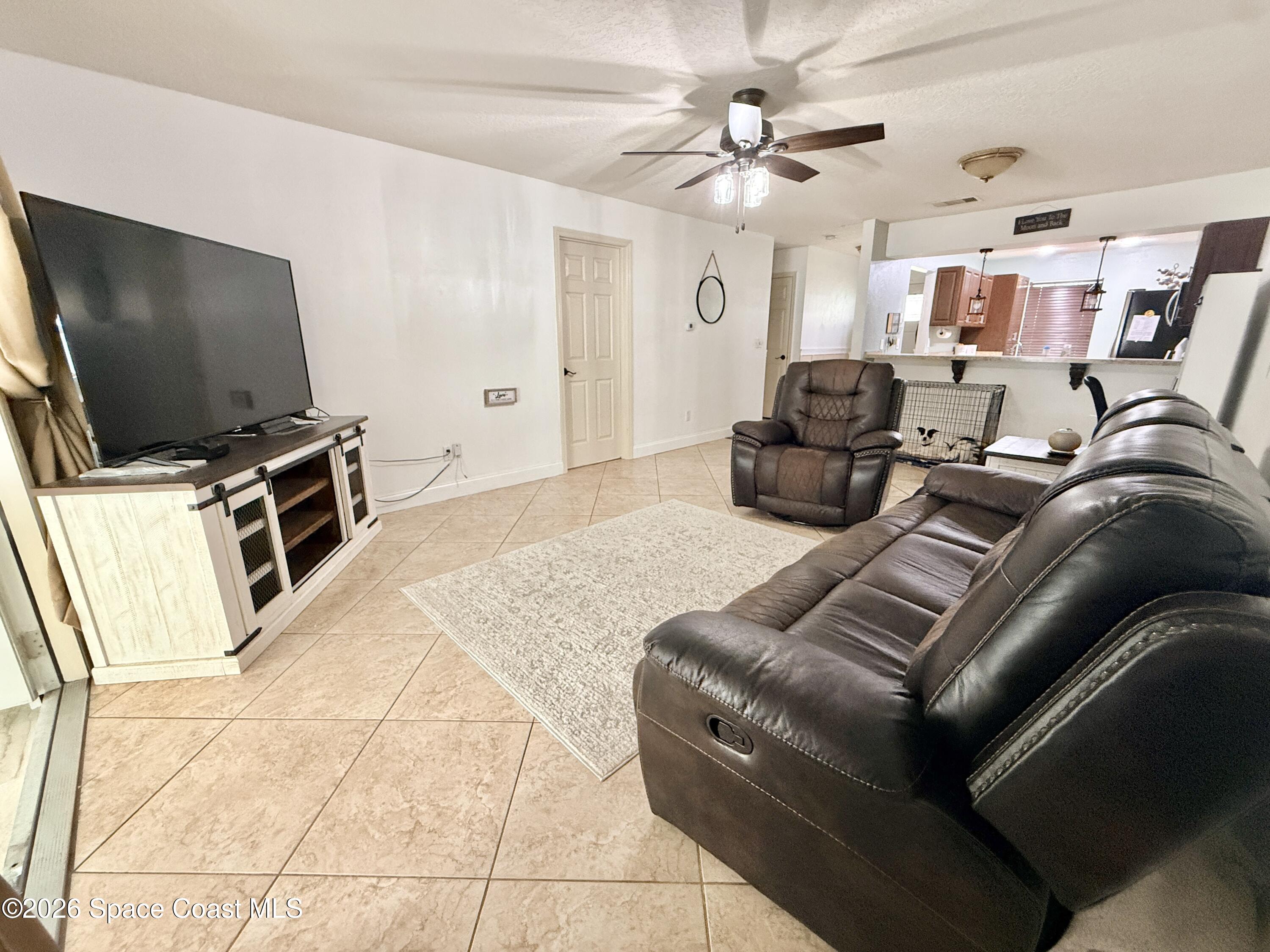 1046 West Samms Avenue Port Orange, FL 32129 - Photo 38 of 53 a living room with furniture and a flat screen tv