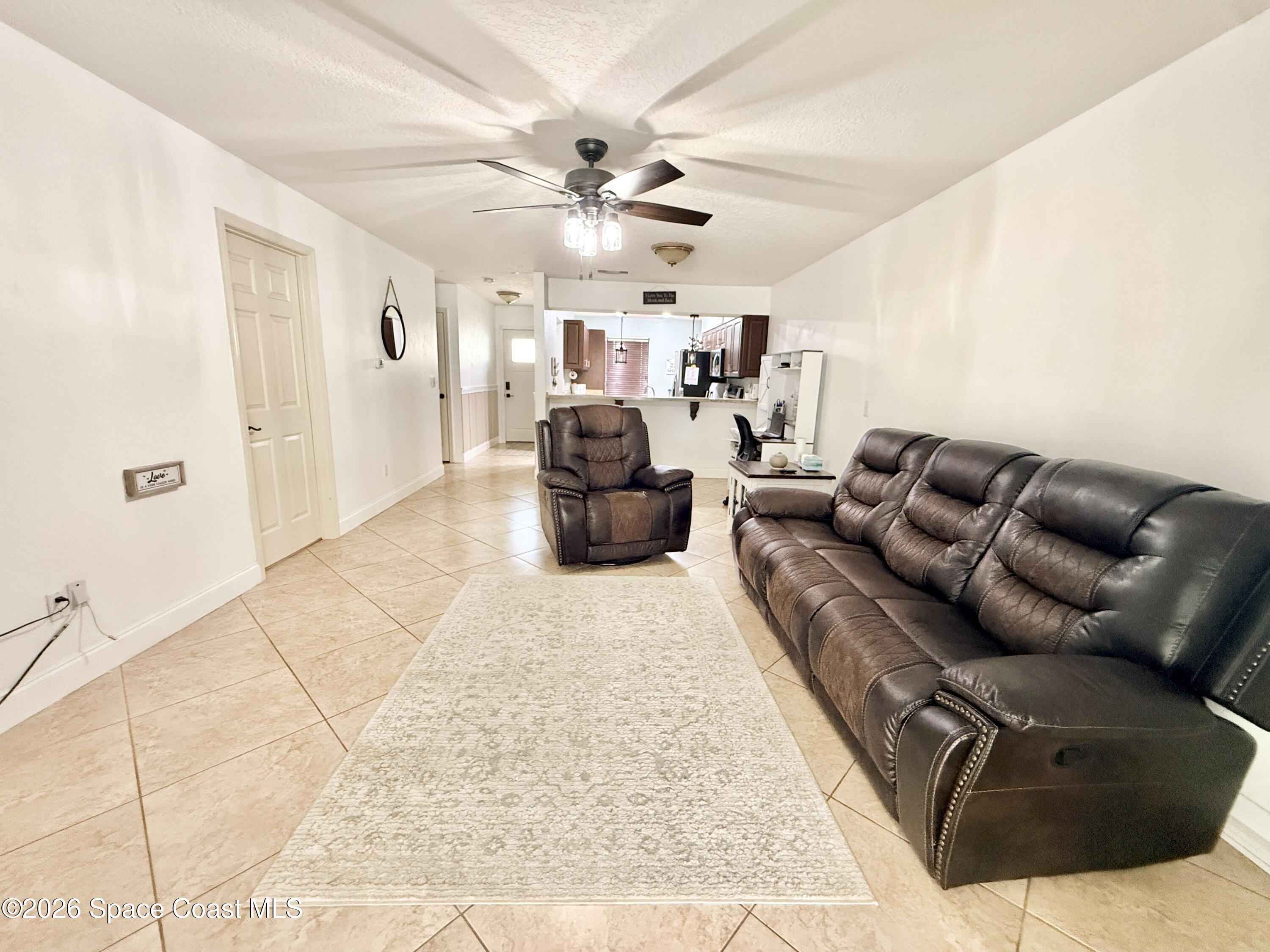 1046 West Samms Avenue Port Orange, FL 32129 - Photo 39 of 53 a living room with furniture and a rug