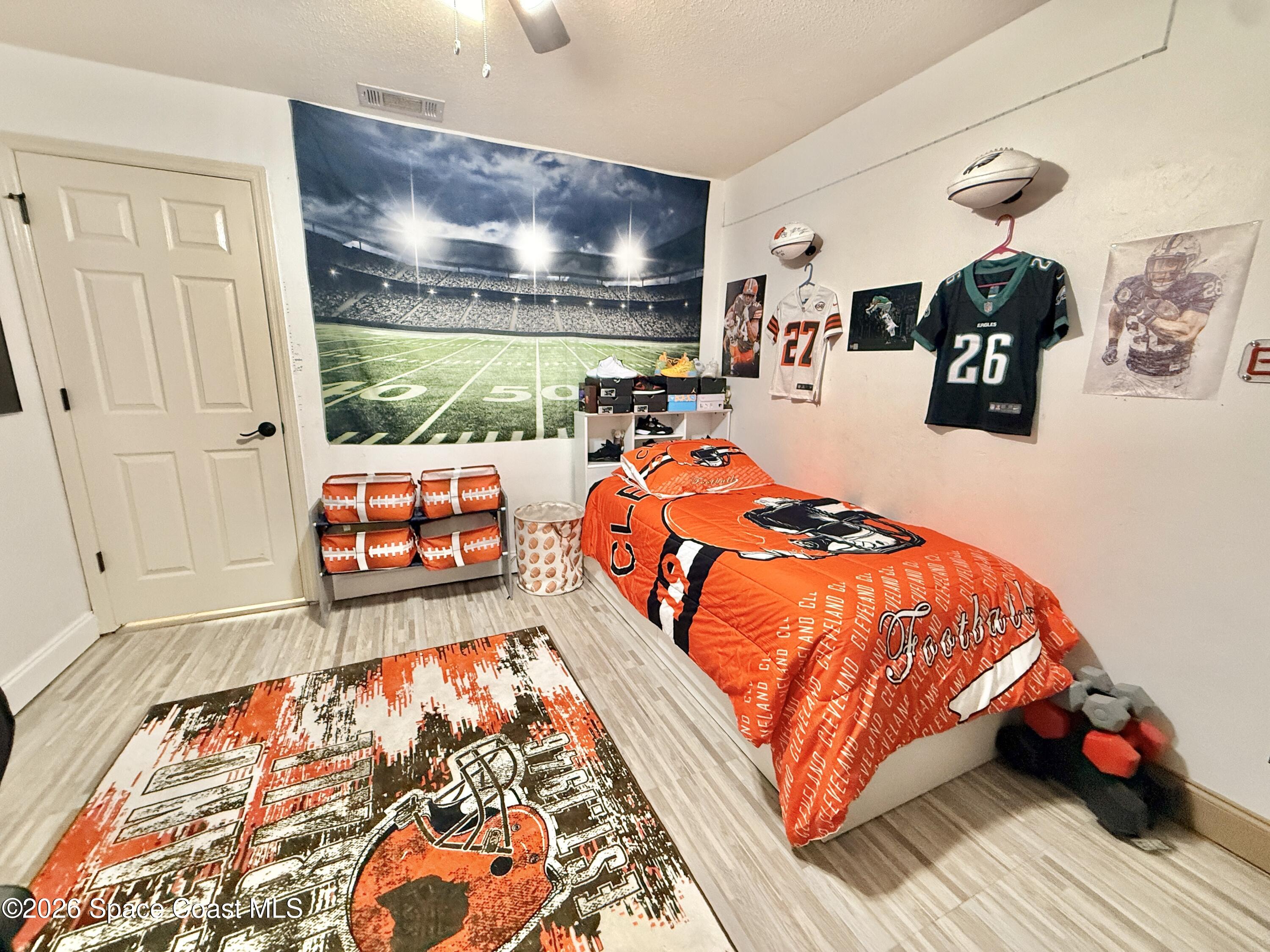 1046 West Samms Avenue Port Orange, FL 32129 - Photo 42 of 53 a bedroom with furniture and wooden floor