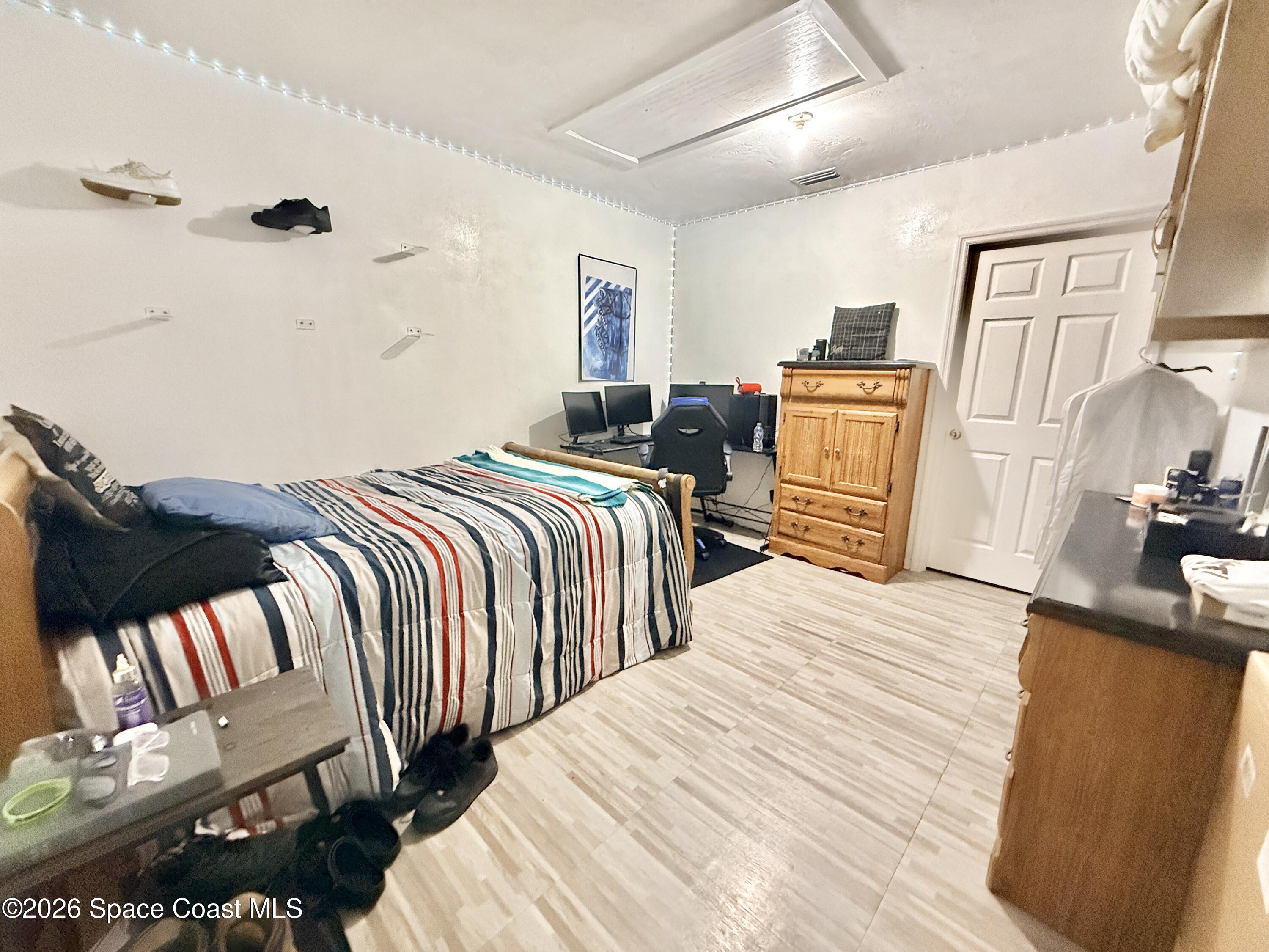 1046 West Samms Avenue Port Orange, FL 32129 - Photo 45 of 53 a bedroom with three beds and painting on the wall