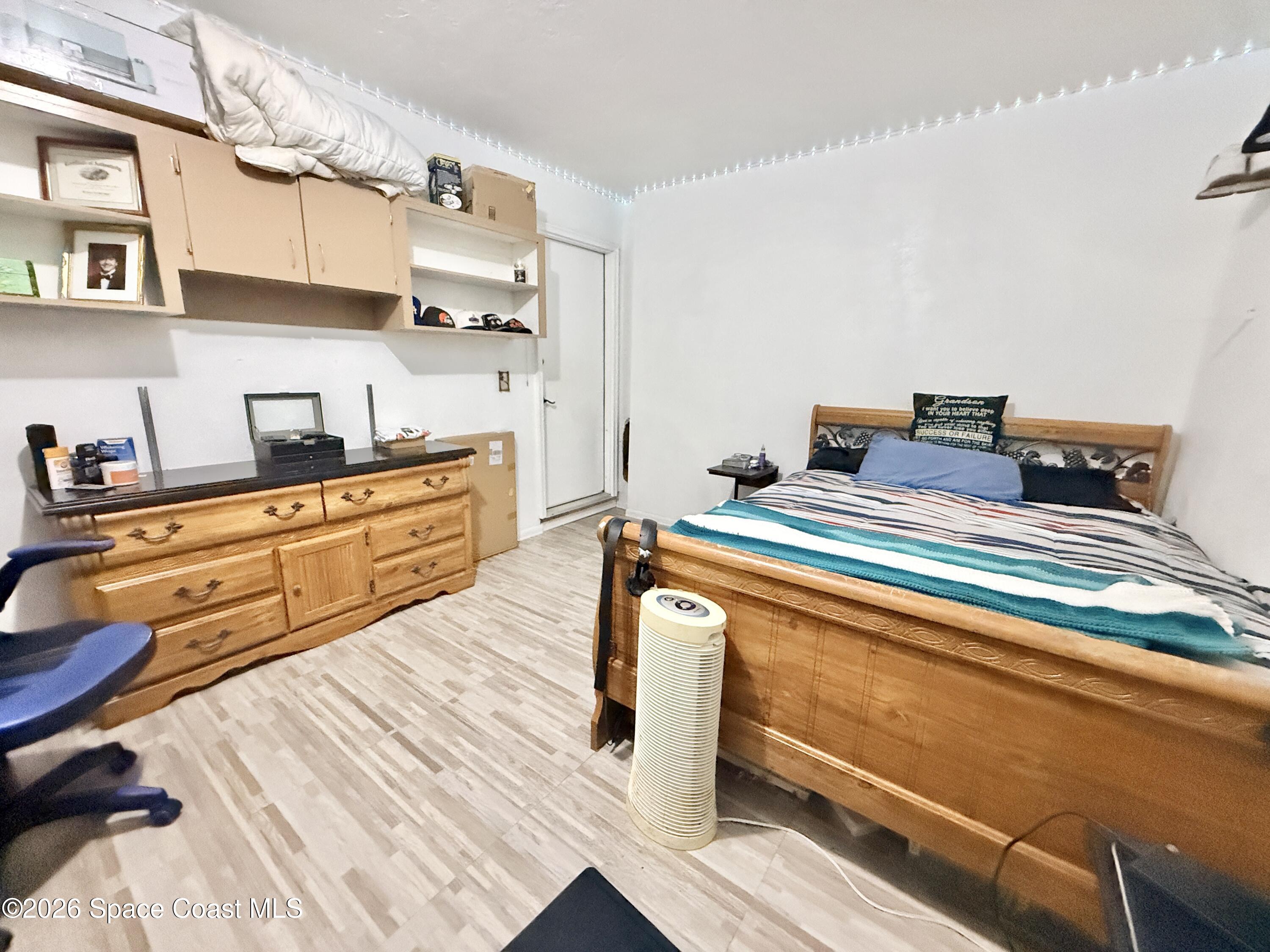 1046 West Samms Avenue Port Orange, FL 32129 - Photo 46 of 53 a bedroom with a bed and a cabinets