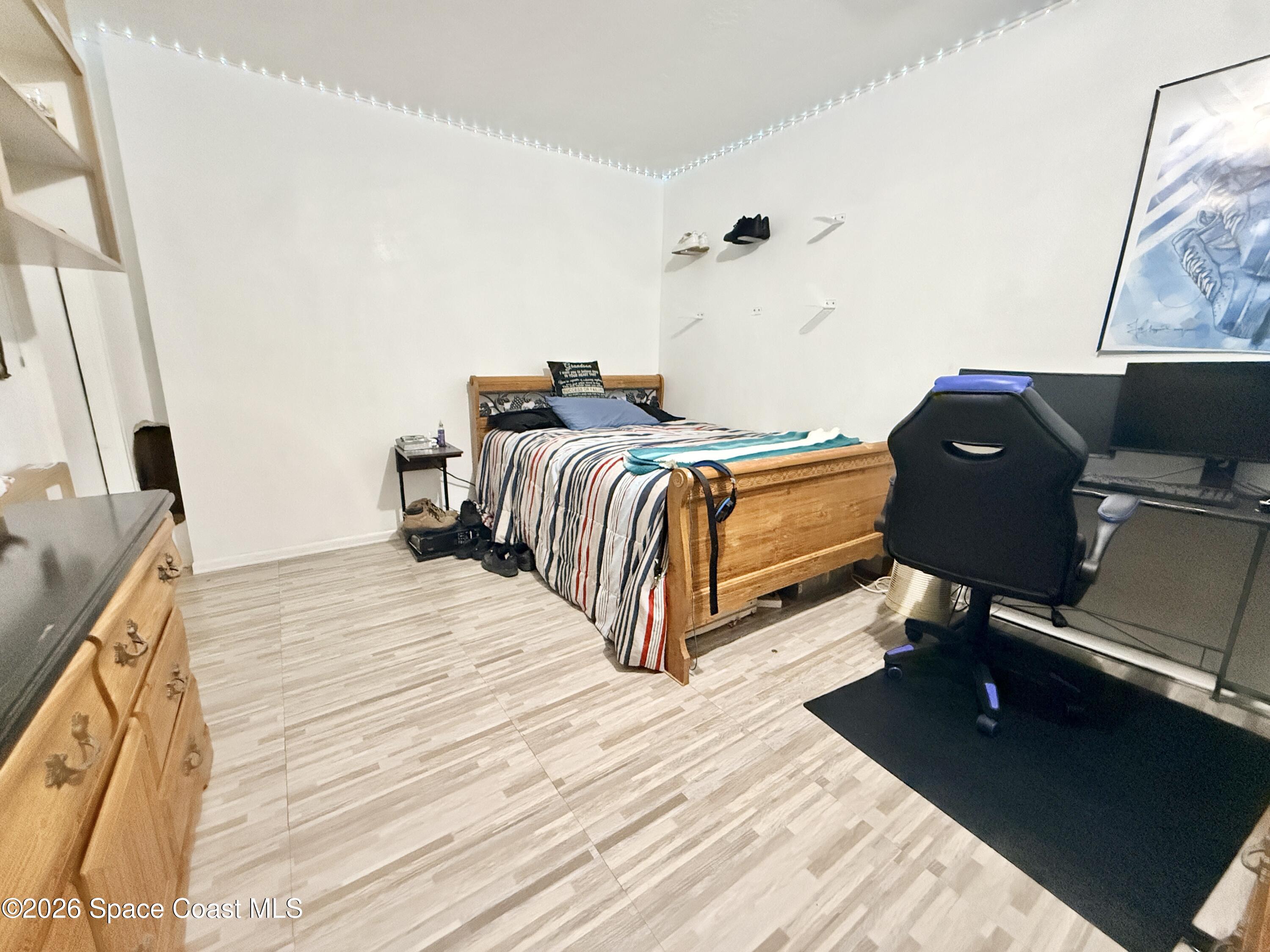 1046 West Samms Avenue Port Orange, FL 32129 - Photo 47 of 53 a bedroom with a bed and wooden floor