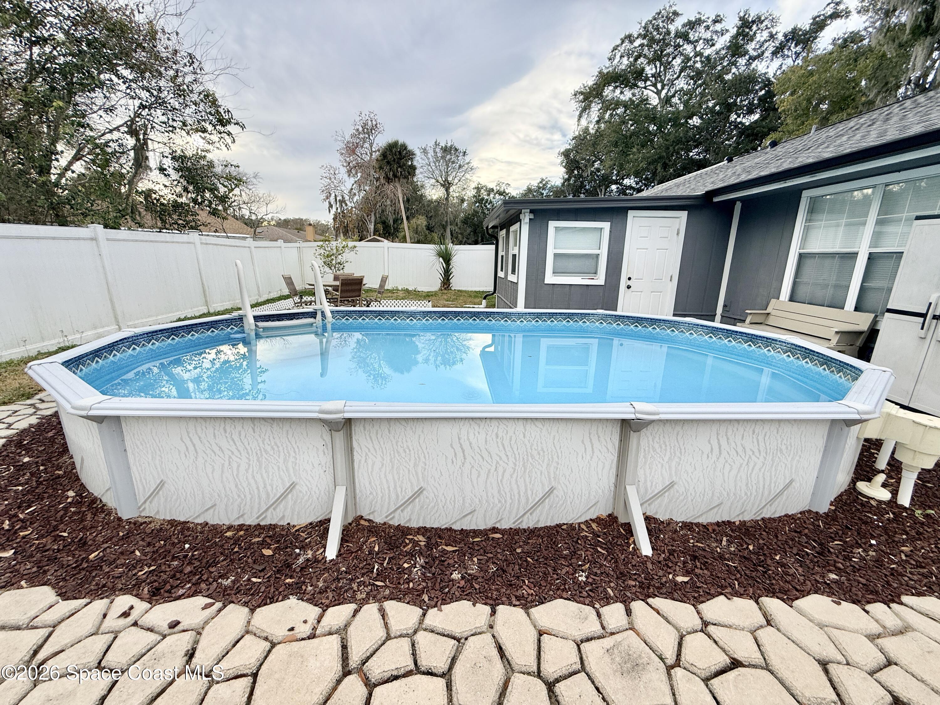 1046 West Samms Avenue Port Orange, FL 32129 - Photo 49 of 53 a view of a backyard with plants and a patio