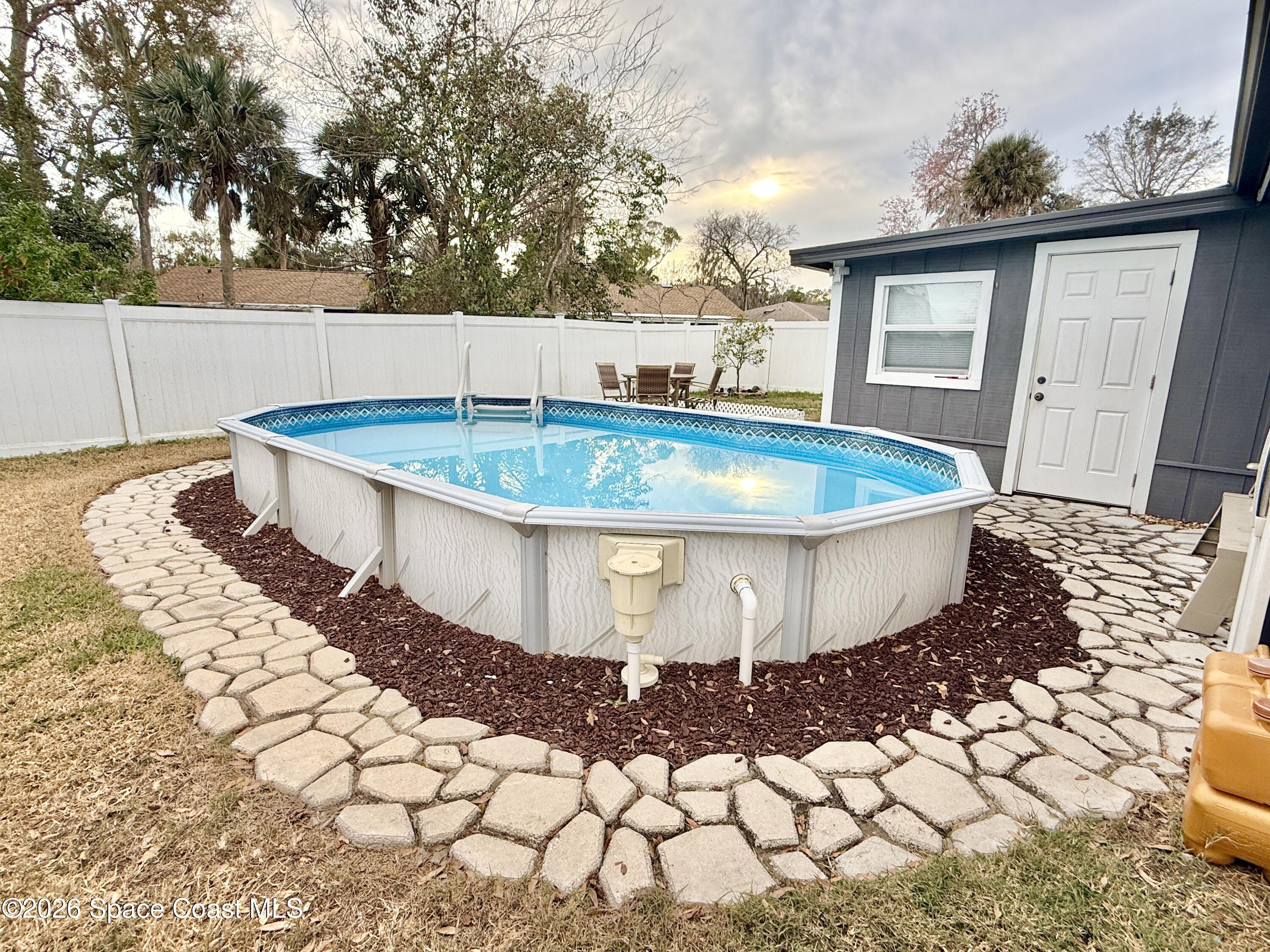 1046 West Samms Avenue Port Orange, FL 32129 - Photo 50 of 53 a view of a swimming pool with a patio