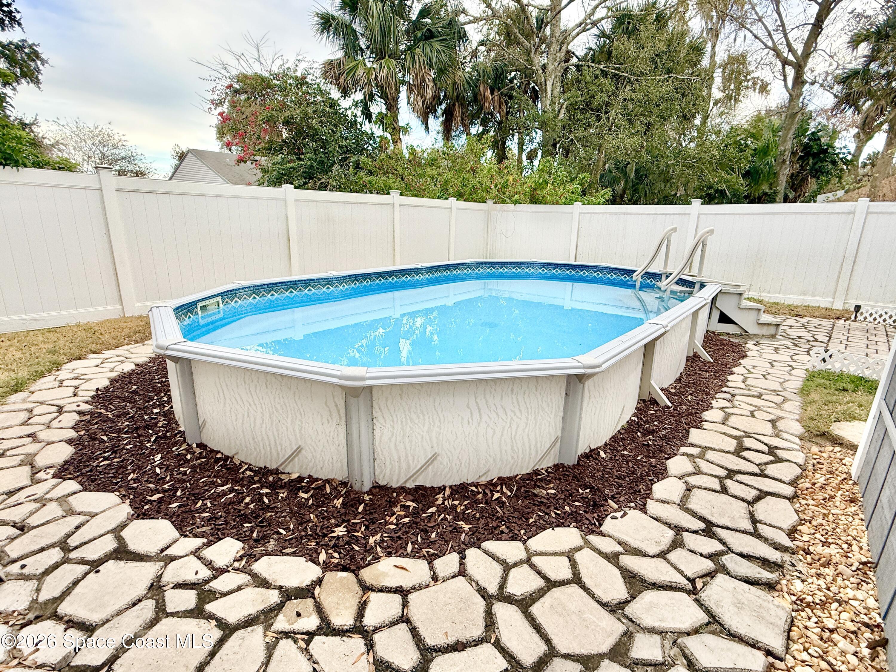 1046 West Samms Avenue Port Orange, FL 32129 - Photo 51 of 53 a view of a swimming pool with an outdoor space