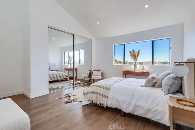 a bedroom with a bed and wooden floor