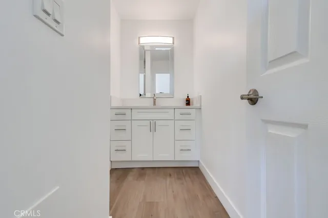 a bathroom with a sink a mirror and a vanity