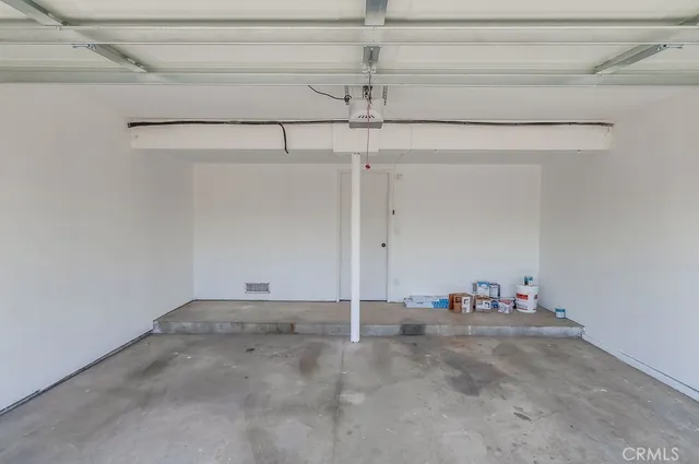 a view of a swimming pool with a patio and wooden fence