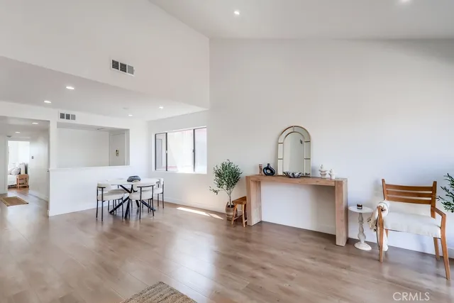 a living room with furniture and view of kitchen