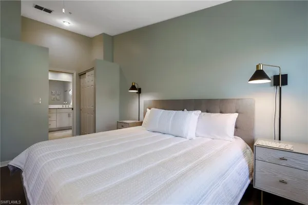 a bedroom with a bed and a night stand