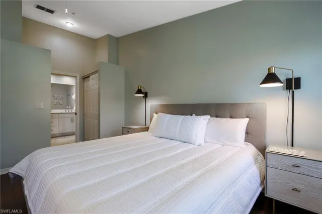 a bedroom with a bed and a night stand