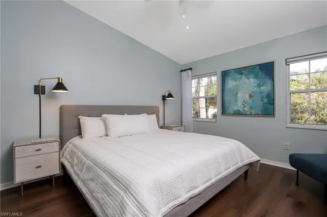 a bedroom with a large bed and a chair