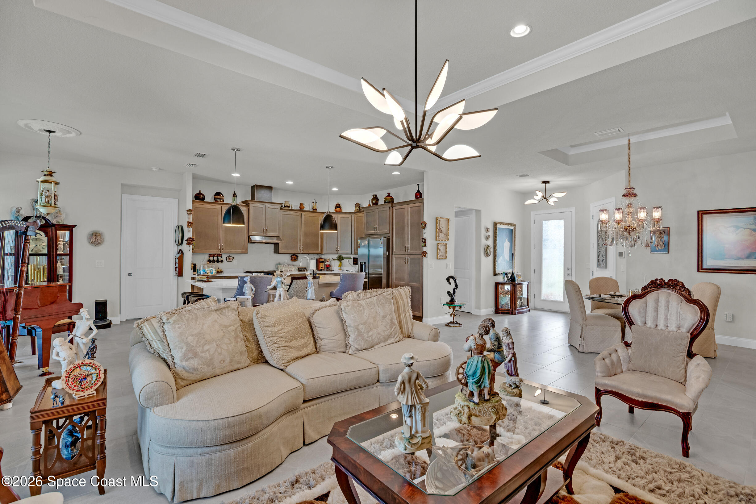 4160 Negal Circle Melbourne, FL 32901 - Photo 11 of 61 a living room with furniture a chandelier and a dining room