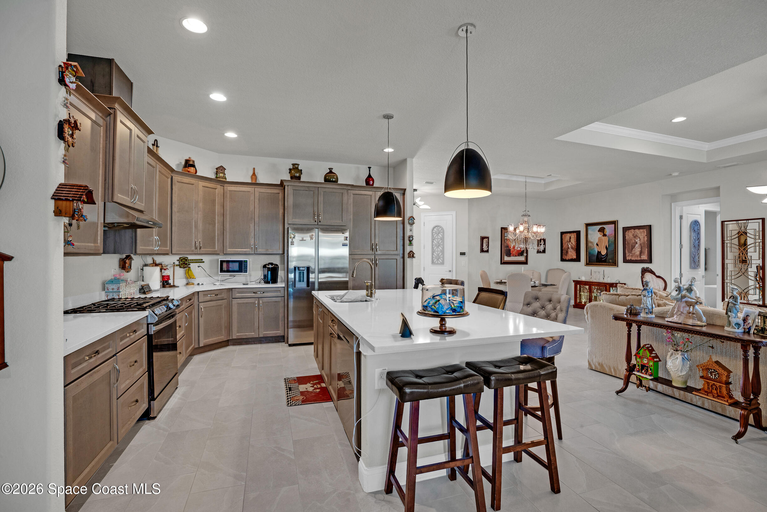 4160 Negal Circle Melbourne, FL 32901 - Photo 14 of 61 a kitchen with stainless steel appliances kitchen island granite countertop a sink and cabinets