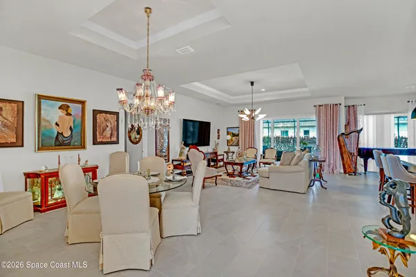 a living room with fireplace furniture and a chandelier