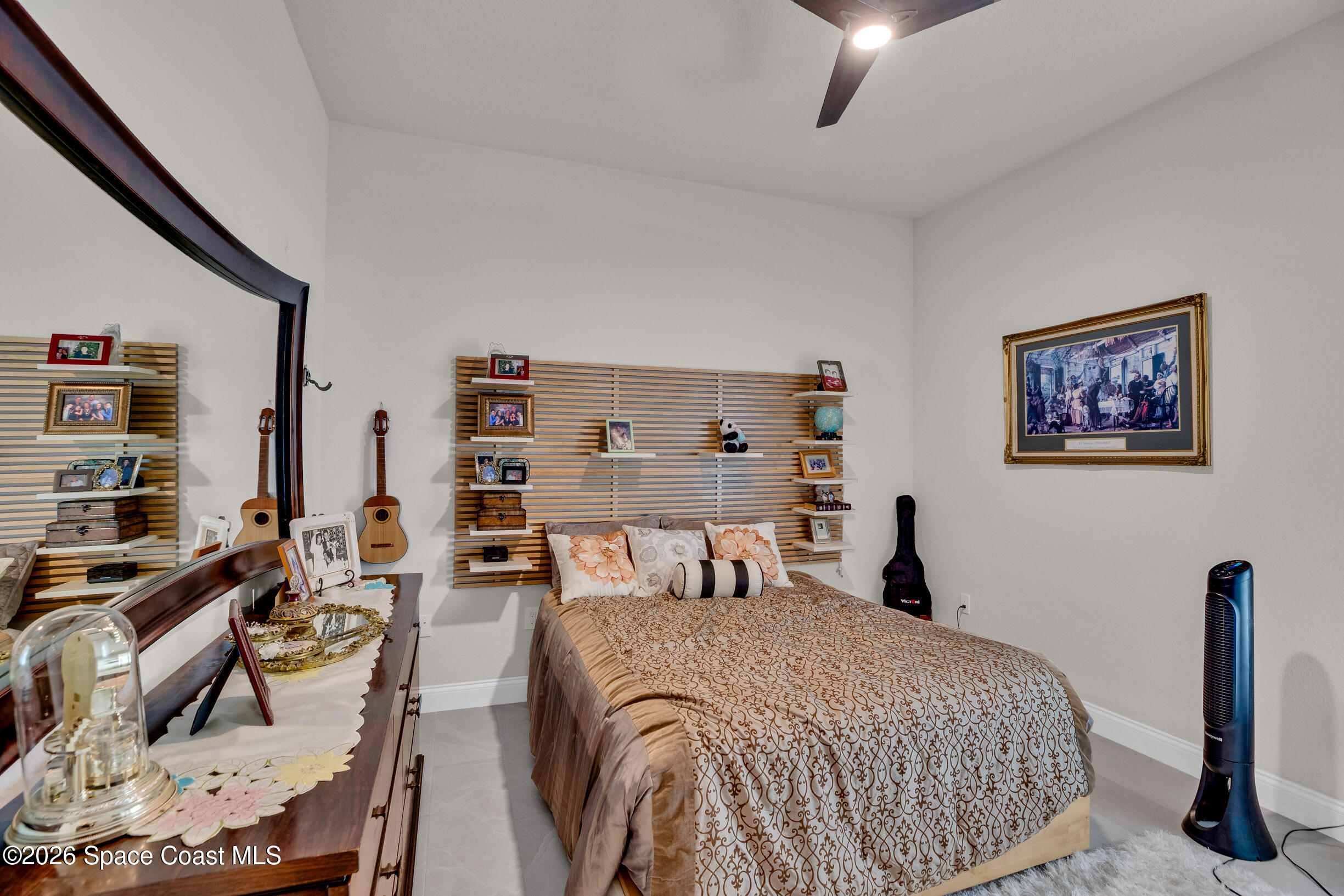 4160 Negal Circle Melbourne, FL 32901 - Photo 21 of 61 a bedroom with a bed and a chandelier