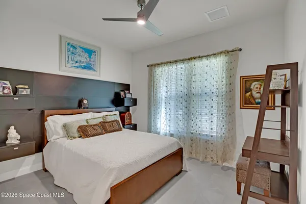 a bedroom with a bed and flat screen tv