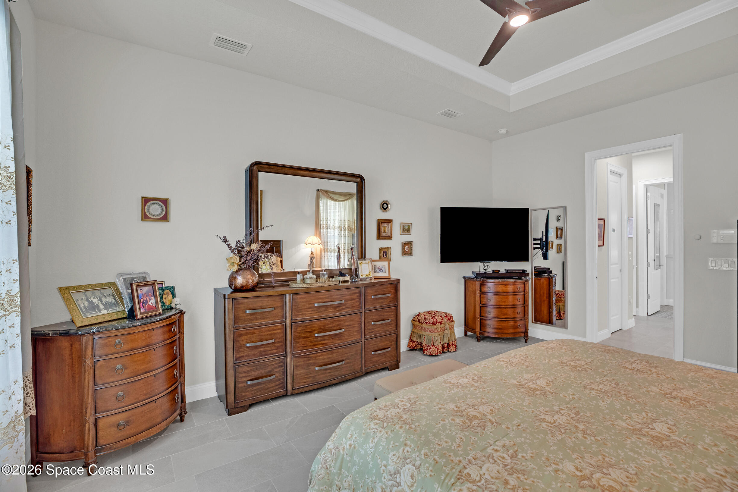 4160 Negal Circle Melbourne, FL 32901 - Photo 30 of 61 a bedroom with a bed and a flat screen tv