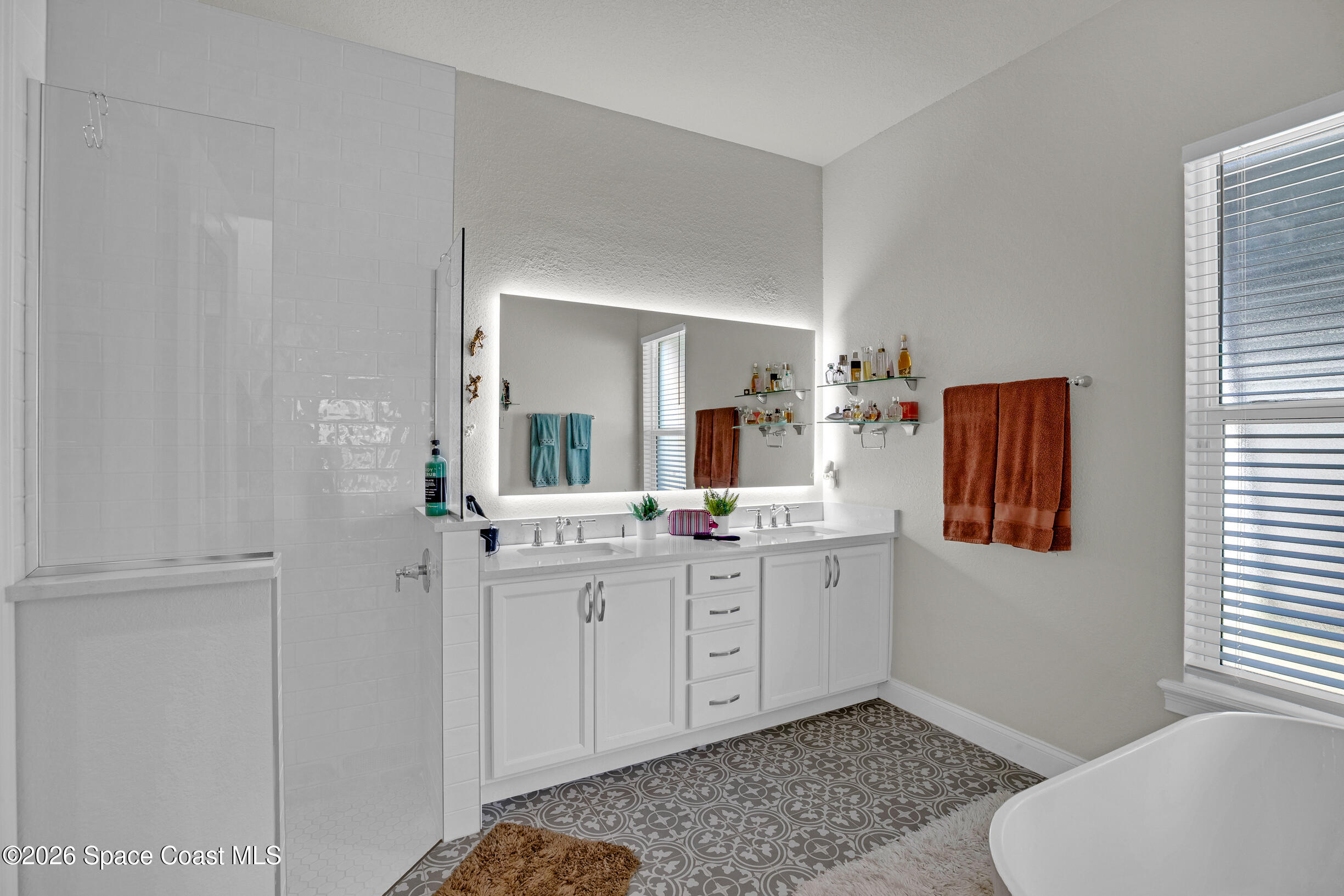 4160 Negal Circle Melbourne, FL 32901 - Photo 33 of 61 a spacious bathroom with a double vanity sink a mirror and a toilet