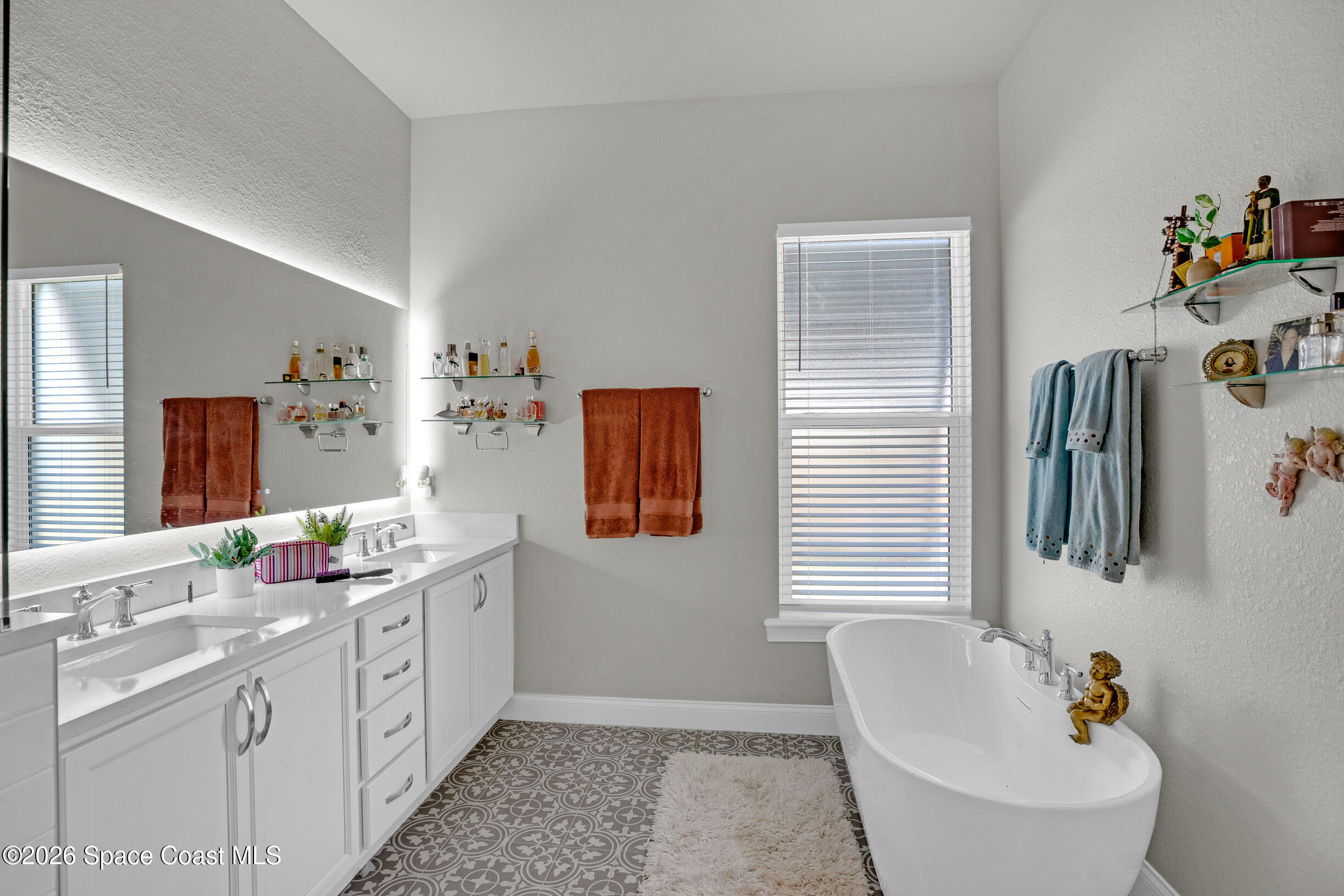 4160 Negal Circle Melbourne, FL 32901 - Photo 34 of 61 a bathroom with double vanity sink and mirror