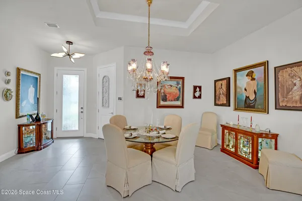 a living room with furniture a flat screen tv and a large window