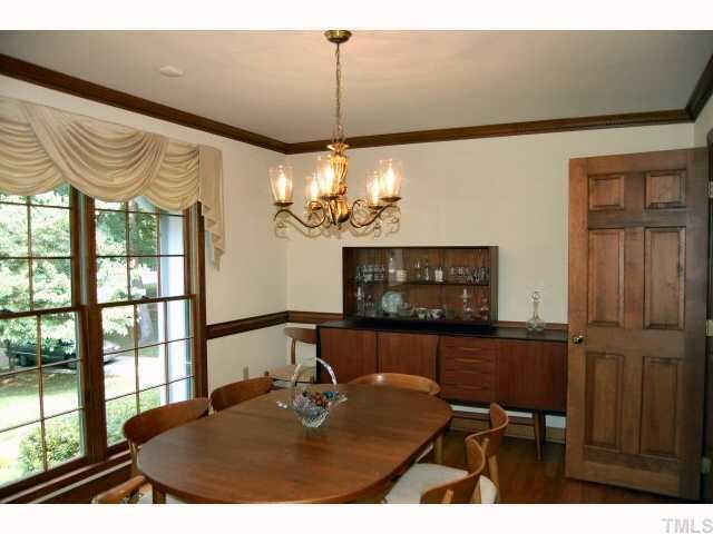 11916 Straight A Way Lane Raleigh, NC 27613 - Photo 5 of 12 a view of a dining room with furniture a chandelier and a window