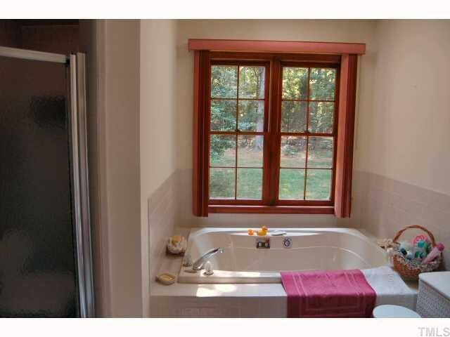11916 Straight A Way Lane Raleigh, NC 27613 - Photo 7 of 12 a bathroom with a bathtub and next to a window