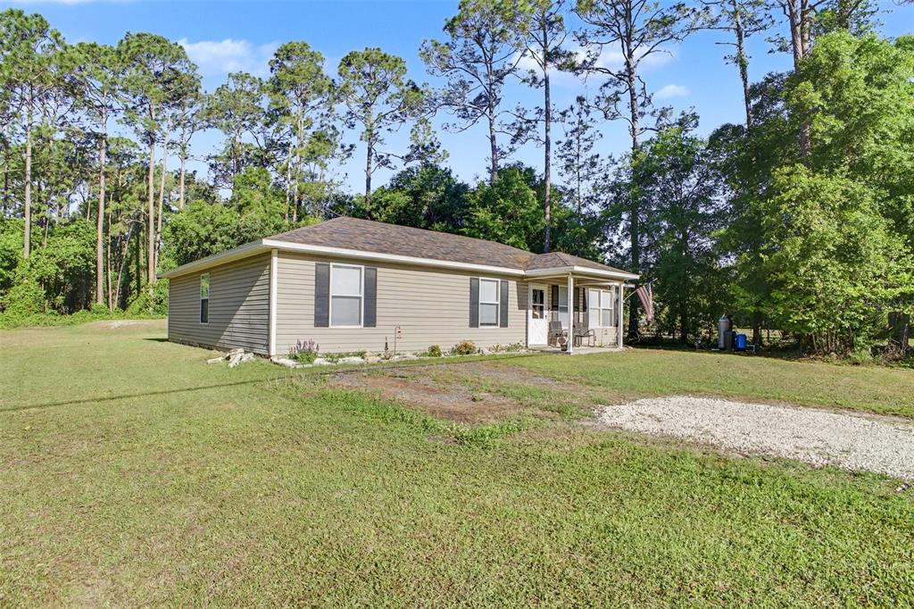 1886 Laurel Avenue Bunnell, FL 32110 - Photo 1 of 31 a front view of house with yard and green space