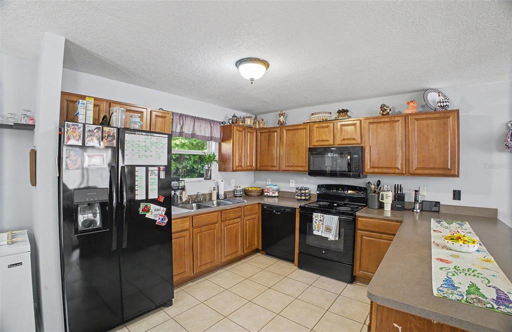 1886 Laurel Avenue Bunnell, FL 32110 - Photo 12 of 31 a kitchen with stainless steel appliances granite countertop a stove top oven